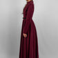 Woman wearing a high quality modest maxi dress in burgundy for graduation or special occasions, with puff sleeves and elegant cotton-blend fabric.