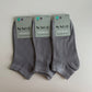 Three pairs of gray socks with Sage packaging on a light gray background