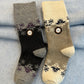 Two pairs of socks with floral -  snowflake design