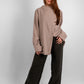 Woman wearing a long sleeve asymmetrical blouse in luxurious premium fabric, tunic length, modest fashion style.