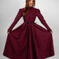 Woman wearing a long sleeve modest maxi dress in burgundy for graduation or special occasions, with puff sleeves and elegant cotton-blend fabric.