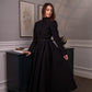 Woman wearing a long sleeve modest maxi dress in black for graduation or special occasions, with puff sleeves and elegant cotton-blend fabric.