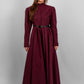 Woman wearing a long sleeve modest maxi dress in burgundy for graduation or special occasions, with puff sleeves and elegant cotton-blend fabric.